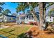 Charming home featuring a screened-in porch and beautifully landscaped front yard with colorful flowers at 2314 Kent Ave, North Charleston, SC 29405