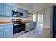Modern kitchen with stainless steel appliances, wooden countertops, and blue cabinets at 2314 Kent Ave, North Charleston, SC 29405