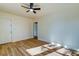 Bright living room with hardwood floors, a ceiling fan, and a white door offering natural light at 2314 Kent Ave, North Charleston, SC 29405