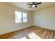 Bright living room with hardwood floors, a ceiling fan, and two large windows offering natural light at 2314 Kent Ave, North Charleston, SC 29405