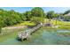 Scenic aerial view of a dock with seating and a covered gazebo in a lush, green waterfront setting at 242 Little Oak Dr, Folly Beach, SC 29439