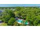Community pool surrounded by lush trees with views of the river at 242 Little Oak Dr, Folly Beach, SC 29439