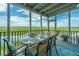 Enjoy outdoor dining on this screened-in balcony with scenic marsh views at 242 Little Oak Dr, Folly Beach, SC 29439