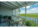Outdoor dining area with seating for six, offering scenic marsh views at 242 Little Oak Dr, Folly Beach, SC 29439