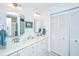 Bright bathroom featuring a double sink vanity and white cabinetry at 242 Little Oak Dr, Folly Beach, SC 29439