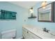 Cozy bathroom with a vanity, toilet, sink, and decor at 242 Little Oak Dr, Folly Beach, SC 29439