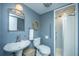 Bathroom featuring a sink, toilet, and accessible shower with a seat at 242 Little Oak Dr, Folly Beach, SC 29439