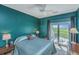 Cozy bedroom with sliding door, ceiling fan, and views of the marsh at 242 Little Oak Dr, Folly Beach, SC 29439