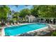 Inviting community pool with lounge chairs, surrounded by lush greenery at 242 Little Oak Dr, Folly Beach, SC 29439