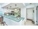 Bright kitchen features white cabinetry, breakfast bar, and stainless steel appliances at 242 Little Oak Dr, Folly Beach, SC 29439