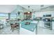 Open kitchen with breakfast bar and living area with fireplace featuring beautiful marsh views at 242 Little Oak Dr, Folly Beach, SC 29439