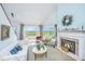 Cozy living room with fireplace, marsh views, and plenty of natural light at 242 Little Oak Dr, Folly Beach, SC 29439