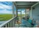Inviting screened patio with seating offers beautiful views of the marsh and waterway at 242 Little Oak Dr, Folly Beach, SC 29439