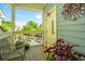 Charming porch area with seating and decor, offering a welcoming outdoor space with a beautiful view at 242 Little Oak Dr, Folly Beach, SC 29439