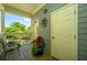 Cozy porch with outdoor seating and potted plants, creating a relaxing entrance with pleasant neighborhood views at 242 Little Oak Dr, Folly Beach, SC 29439