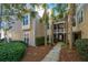 Attractive multi-story condo exterior with lush landscaping and mature palm trees at 2522 Egret Crest Ln, Charleston, SC 29414