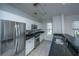 Modern kitchen with stainless steel appliances, white cabinets, and dark countertops at 2522 Egret Crest Ln, Charleston, SC 29414