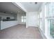 Open-concept living space with natural light, neutral tones, and a view of the adjacent kitchen at 2522 Egret Crest Ln, Charleston, SC 29414