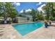 Community swimming pool with brick patio, lounge chairs, and lush landscaping at 2522 Egret Crest Ln, Charleston, SC 29414