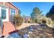 Beautiful backyard with brick steps, lush landscaping, and a glimpse of the pond and neighboring houses at 2707 Waterpointe Cir, Mount Pleasant, SC 29466
