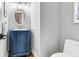 Charming powder room with blue vanity, decorative mirror, and elegant fixtures at 2707 Waterpointe Cir, Mount Pleasant, SC 29466