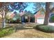 Charming brick home featuring mature trees, a manicured lawn, and an attached two car garage at 2707 Waterpointe Cir, Mount Pleasant, SC 29466