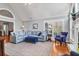 Spacious living room featuring hardwood floors, plantation shutters, and a comfortable sectional sofa at 2707 Waterpointe Cir, Mount Pleasant, SC 29466