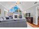 Bright living room with large arched window, fireplace, ceiling fan, and hardwood floors at 2707 Waterpointe Cir, Mount Pleasant, SC 29466