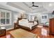 Large main bedroom with tray ceiling, plantation shutters, and hardwood floors at 2707 Waterpointe Cir, Mount Pleasant, SC 29466