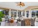 Bright sunroom with neutral décor, comfortable seating, and views of the landscaped backyard at 2707 Waterpointe Cir, Mount Pleasant, SC 29466