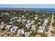 Expansive aerial view of a coastal neighborhood showcasing lush greenery and beautiful homes near the waterfront at 3006 Cameron Blvd, Isle of Palms, SC 29451