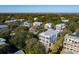 Aerial view of a coastal home with a two-story porch and beautiful neighborhood nestled among trees at 3006 Cameron Blvd, Isle of Palms, SC 29451