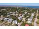 This coastal neighborhood aerial view features lovely homes nestled between lush greenery and blue waterways at 3006 Cameron Blvd, Isle of Palms, SC 29451