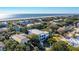 Scenic aerial view of a beachfront community with houses nestled among lush greenery, ocean in the distance at 3006 Cameron Blvd, Isle of Palms, SC 29451