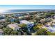 An aerial view of a charming coastal home nestled among lush trees, near the beach and ocean at 3006 Cameron Blvd, Isle of Palms, SC 29451