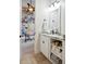 Well-lit bathroom with marble countertop and open shelving for storage, leading into office at 3006 Cameron Blvd, Isle of Palms, SC 29451