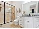 Bathroom with glass shower, granite counters, white cabinets, and decorative mirrors at 3006 Cameron Blvd, Isle of Palms, SC 29451