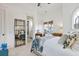 Bedroom boasting high ceilings, a decorative mirror, and a view into an ensuite bathroom and an office at 3006 Cameron Blvd, Isle of Palms, SC 29451