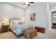 Bright bedroom with a ceiling fan, two wooden trunks, an artistic wall painting and an elegant patterned comforter at 3006 Cameron Blvd, Isle of Palms, SC 29451
