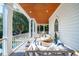 Inviting covered porch with comfortable seating offering outdoor relaxation with a serene poolside view at 3006 Cameron Blvd, Isle of Palms, SC 29451