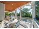 Relaxing covered porch featuring a dining table with chairs and outdoor furniture with a pool view at 3006 Cameron Blvd, Isle of Palms, SC 29451