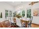 Bright dining room with large windows, wood floors, and modern chandelier above the table at 3006 Cameron Blvd, Isle of Palms, SC 29451