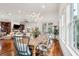 Open-concept dining area with hardwood floors, modern lighting, and large windows at 3006 Cameron Blvd, Isle of Palms, SC 29451