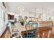 Open dining room with hardwood floors, stylish chandelier, and views into the gourmet kitchen at 3006 Cameron Blvd, Isle of Palms, SC 29451