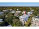 A beautiful coastal home with multiple decks and floors is surrounded by lush trees in this scenic aerial view at 3006 Cameron Blvd, Isle of Palms, SC 29451