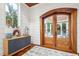 Bright foyer featuring shiplap walls, hardwood floors, arched glass paneled doors and a stylish sideboard at 3006 Cameron Blvd, Isle of Palms, SC 29451