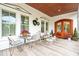 Inviting front porch with a charming seating area, perfect for relaxing and enjoying the outdoors at 3006 Cameron Blvd, Isle of Palms, SC 29451