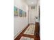 Hallway featuring hardwood floors, a patterned rug, and modern art decorations at 3006 Cameron Blvd, Isle of Palms, SC 29451