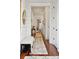 This home features a long hallway with hardwood floors, shiplap walls and decorative rug at 3006 Cameron Blvd, Isle of Palms, SC 29451