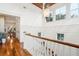 Second story hallway with hardwood floors, wood ceiling and a modern pineapple chandelier at 3006 Cameron Blvd, Isle of Palms, SC 29451